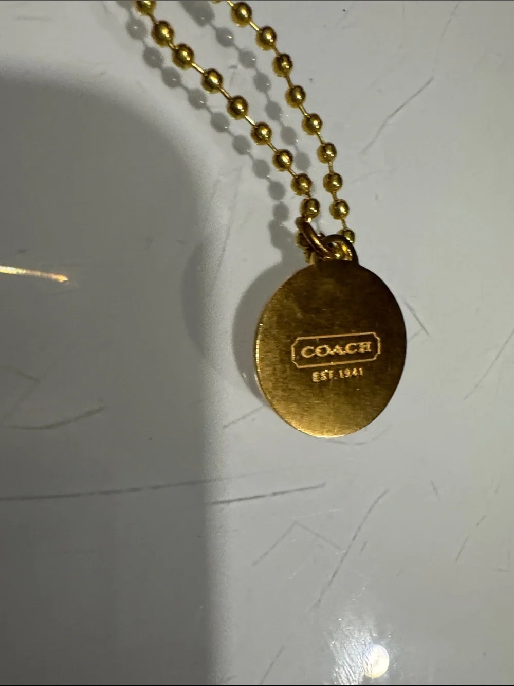 Coach gold tone